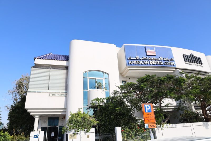 American Dental Clinic building on Jumeira Street: a white villa with the blue American Dental Clinic sign in English and Arabic